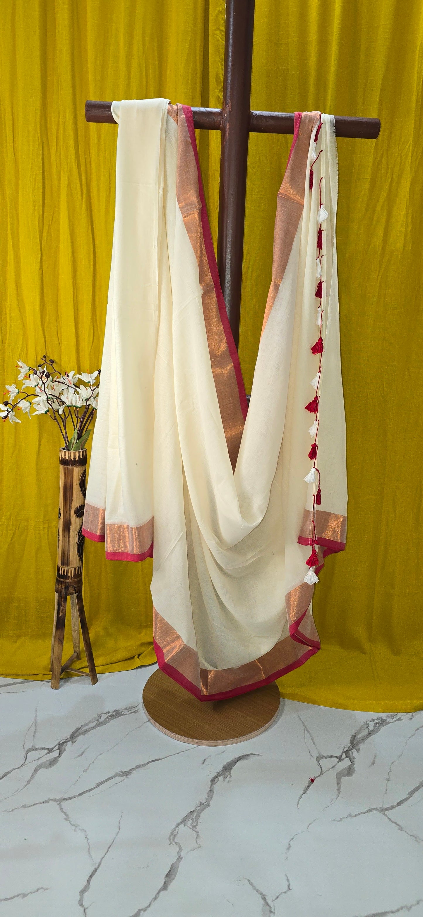 Cream Mul Cotton Saree with Copper Zari Border and Red-White Tassel Detailing