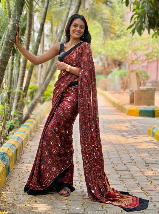 Rust Red Modal Silk Saree with Mirror Work & Ajrakh-Inspired Prints