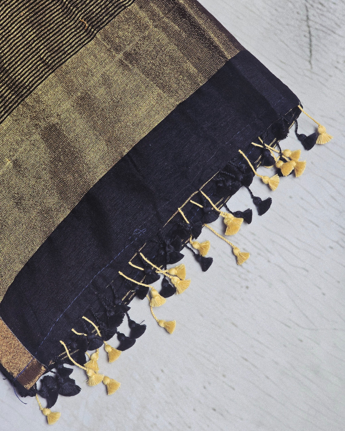 Deep navy Mul Cotton saree close-up with gold zari and tassels