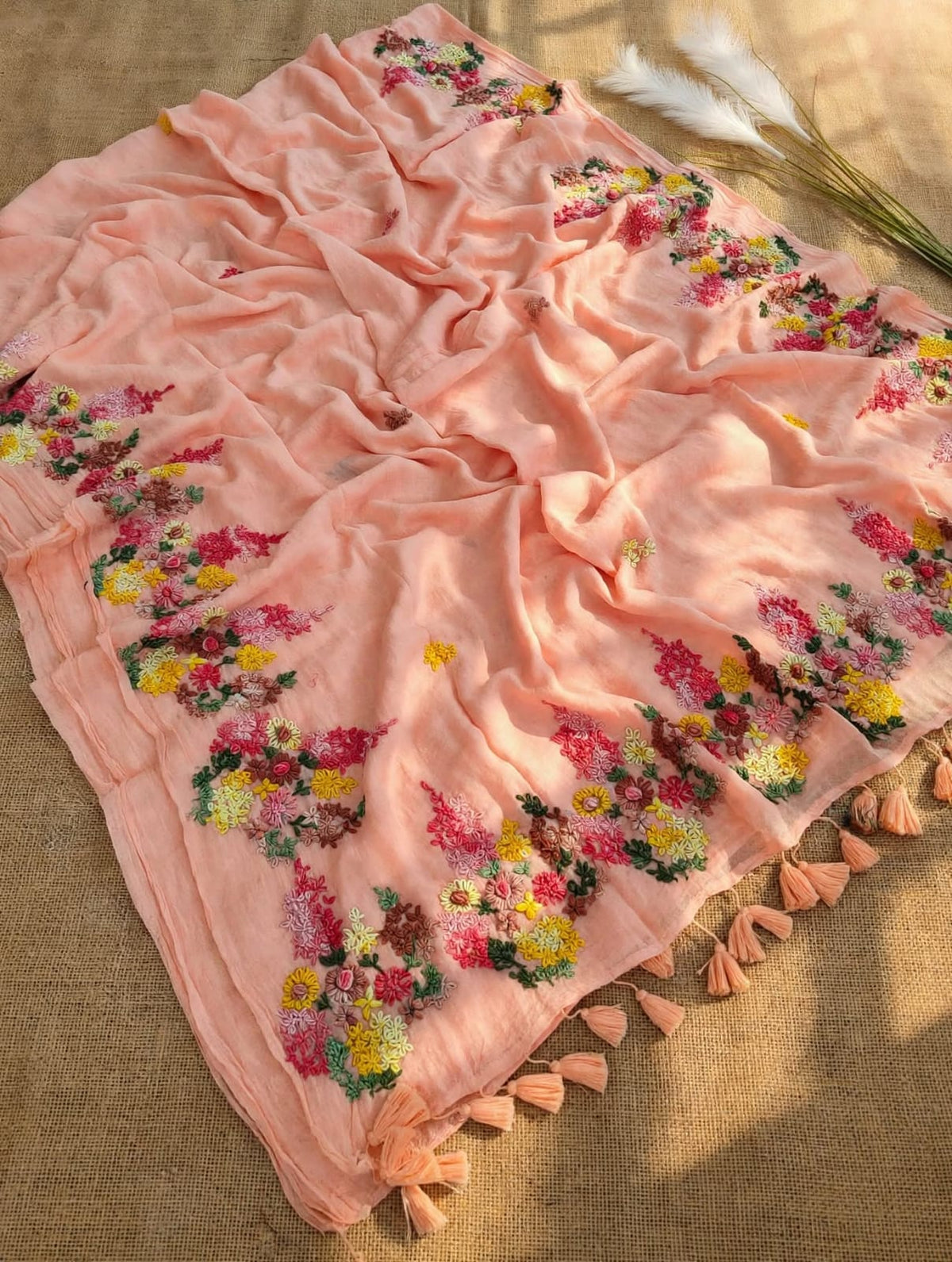 Peach mul cotton saree with multicolour floral embroidery and peach tassels