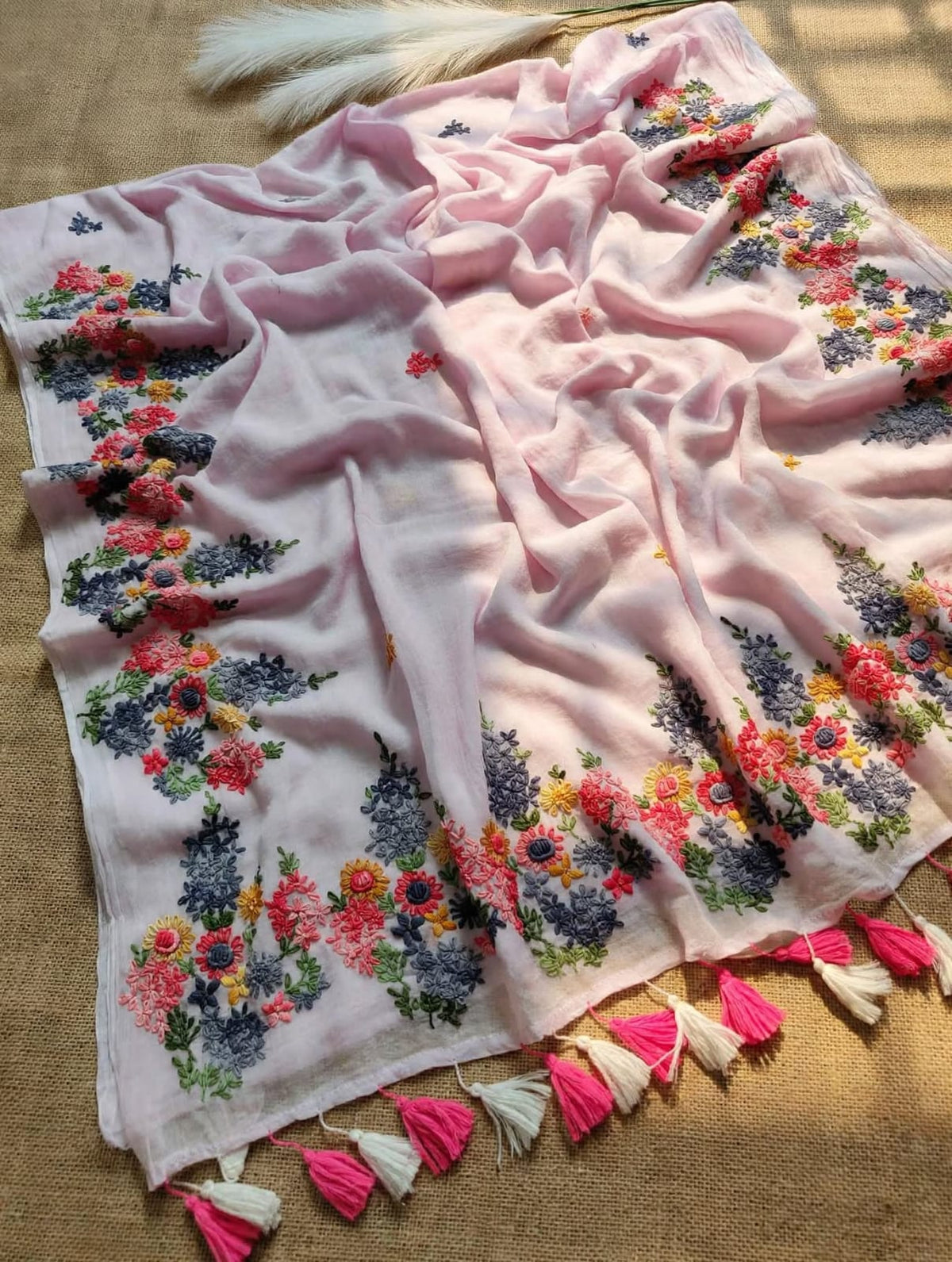 Blush pink and white mul cotton saree with multicolour floral embroidery and pink and ivory tassels