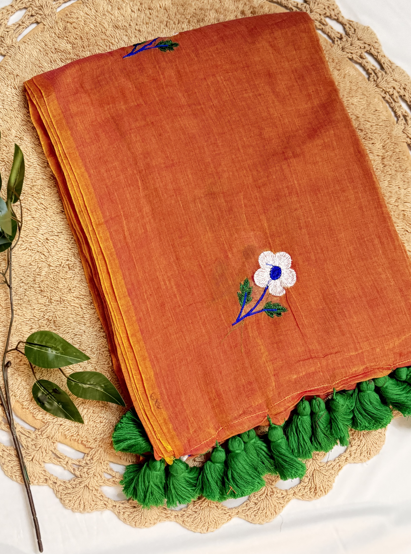 Rust Orange Mul Cotton Saree with Floral Embroidery & Green Tassels