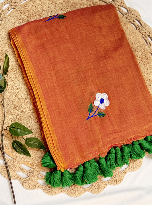 Rust Orange Mul Cotton Saree with Floral Embroidery & Green Tassels