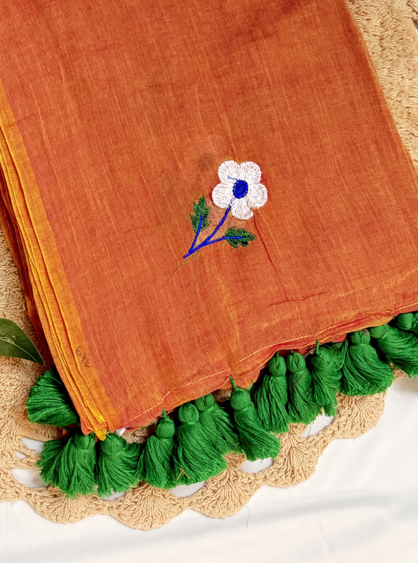 Rust Orange Mul Cotton Saree with Floral Embroidery & Green Tassels