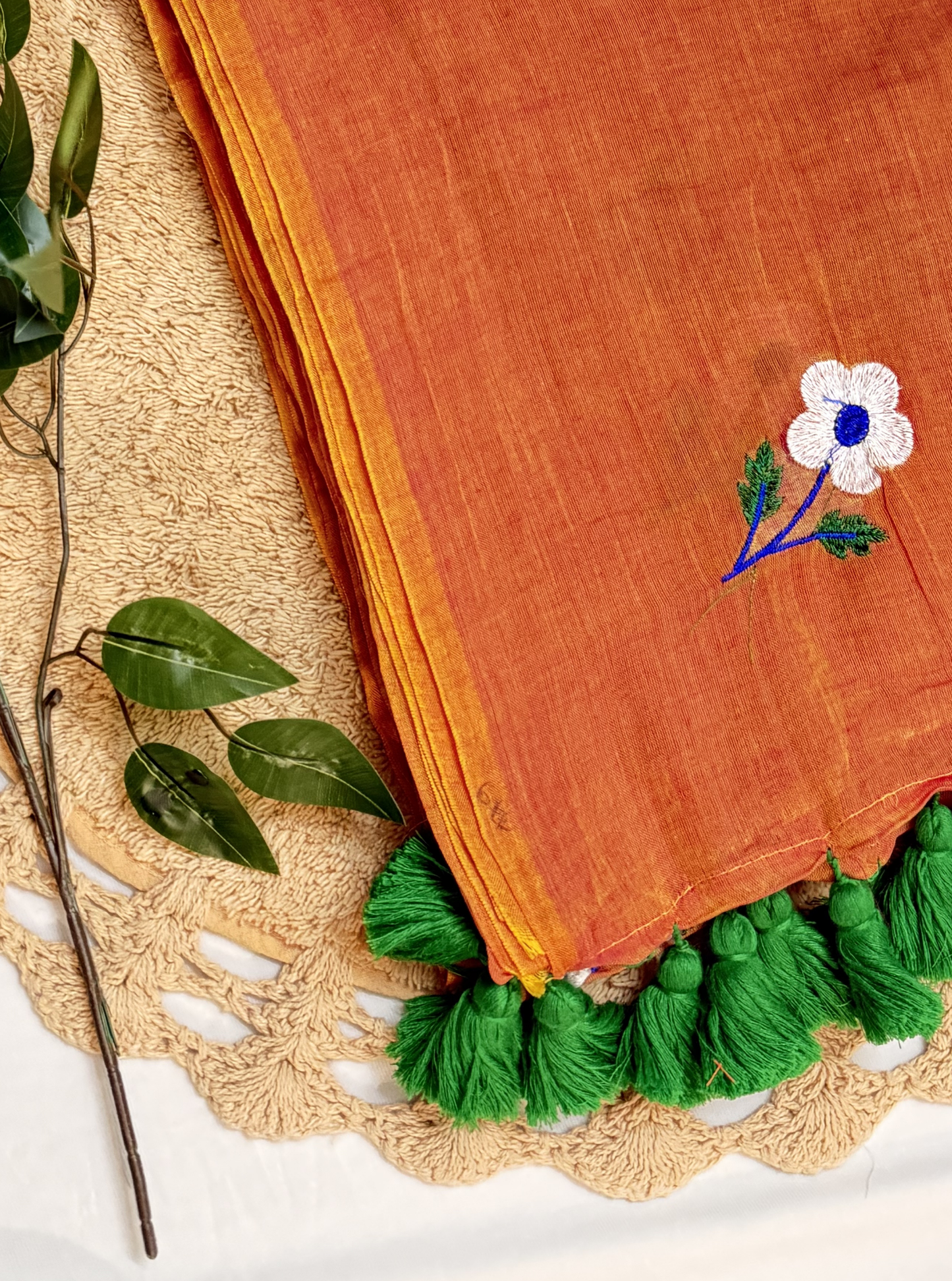 Rust Orange Mul Cotton Saree with Floral Embroidery & Green Tassels