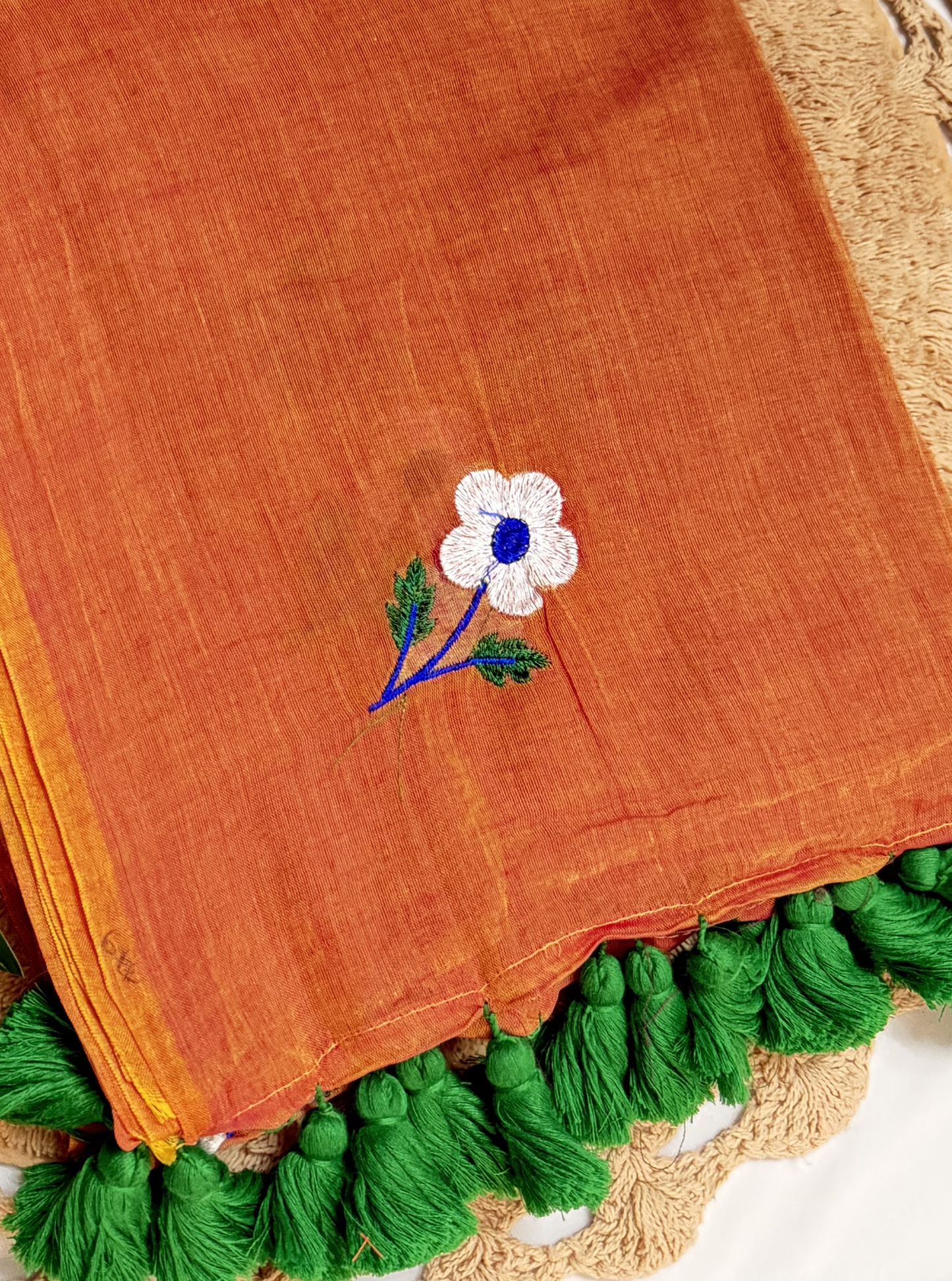 Rust Orange Mul Cotton Saree with Floral Embroidery & Green Tassels