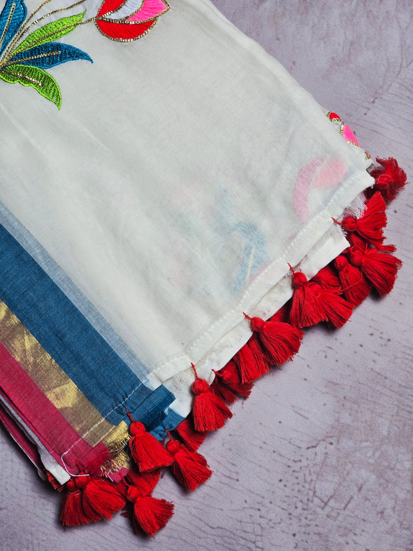 Ivory and Blue Mul Cotton Saree with Multicolour Floral Embroidery & Red Tassels