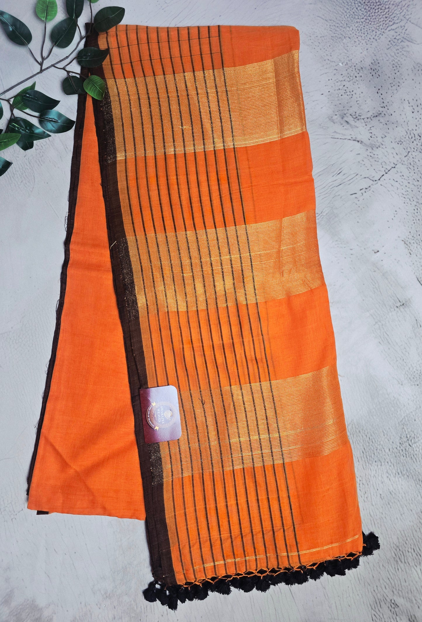 Orange and Dark Brown Mull Cotton Saree with Gold Zari Panels & Black Tassels
