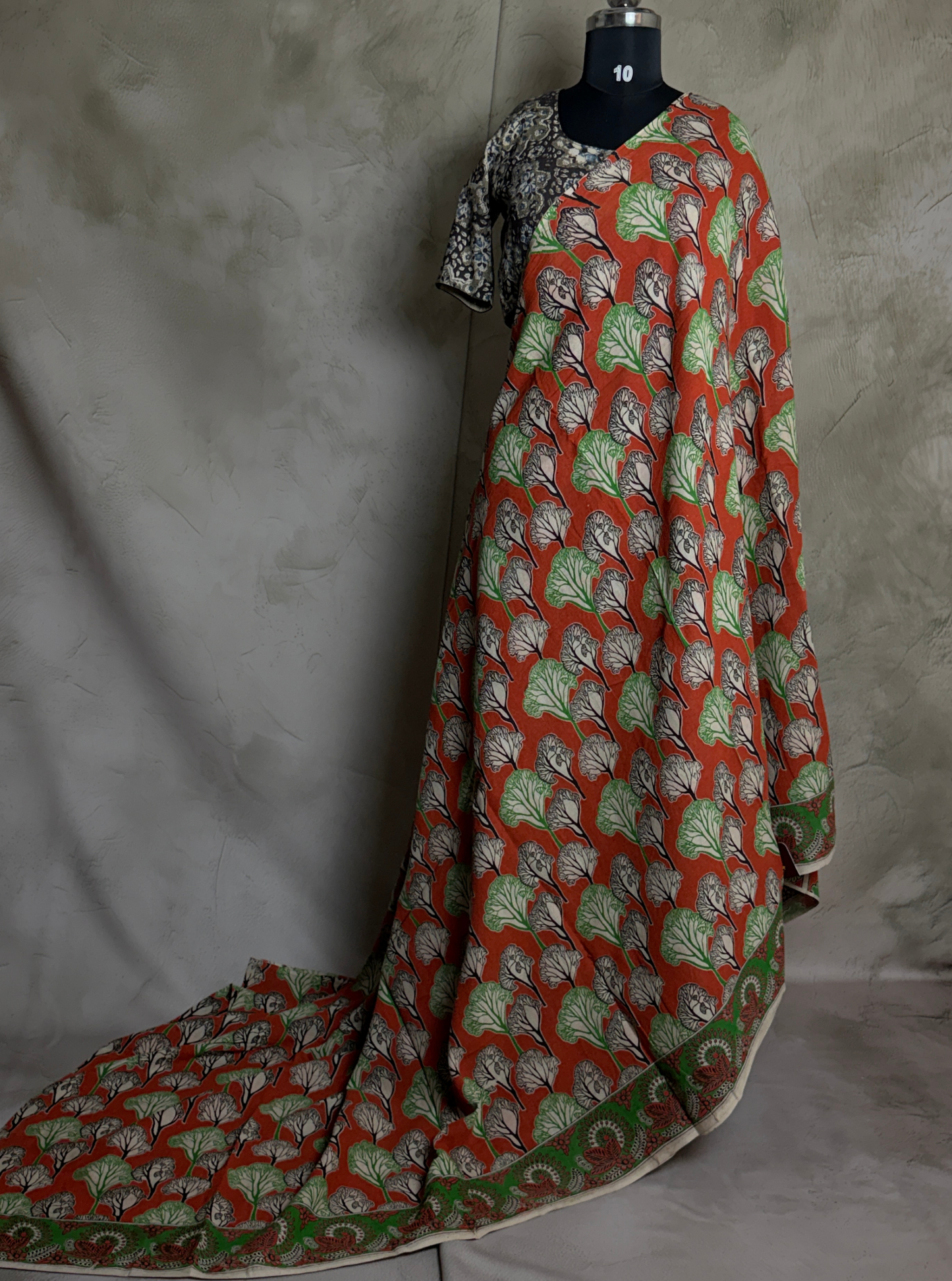 Rust Orange Cotton Kalamkari Saree with Leaf Motifs & Green Border