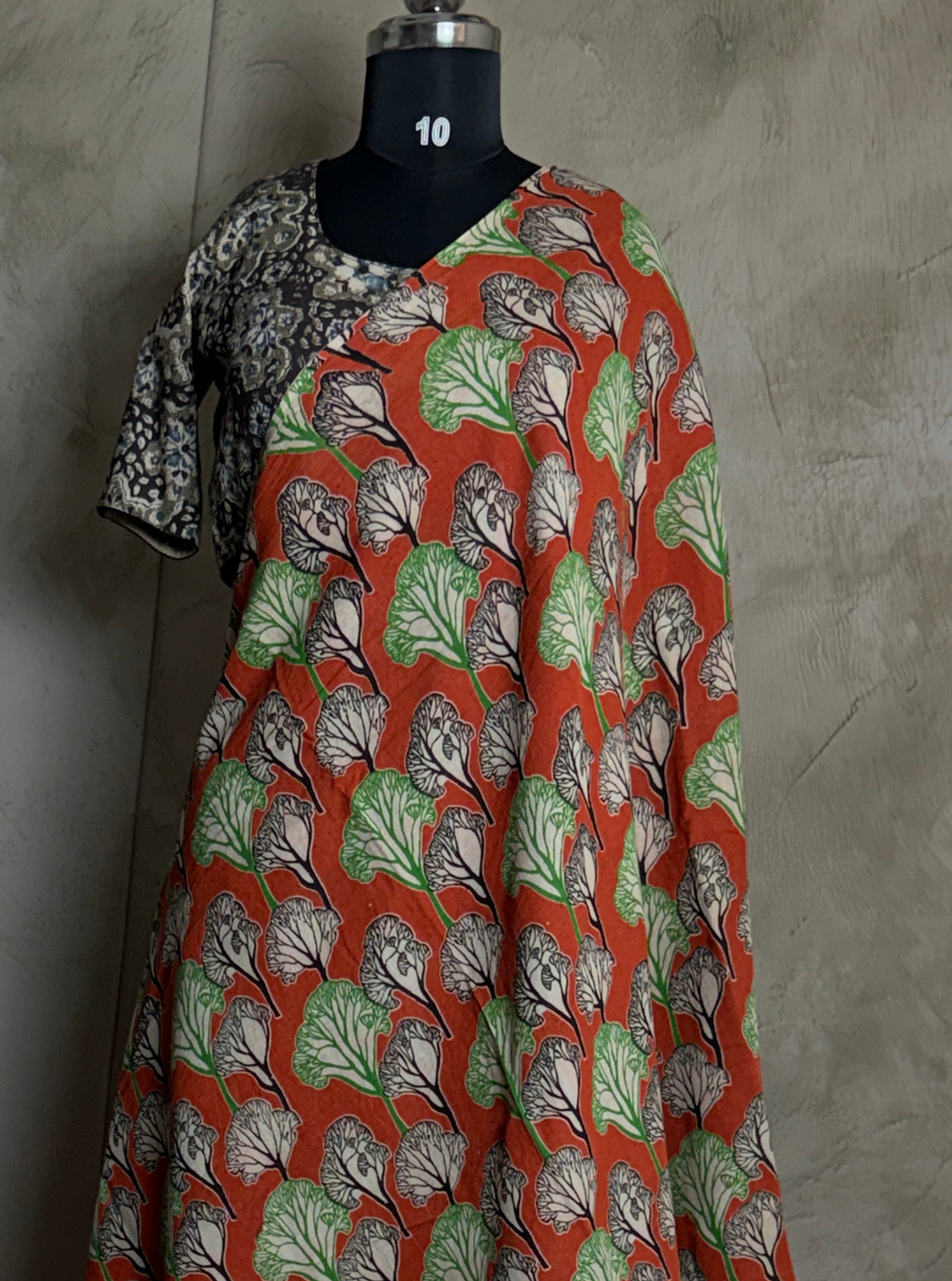 Rust Orange Cotton Kalamkari Saree with Leaf Motifs & Green Border