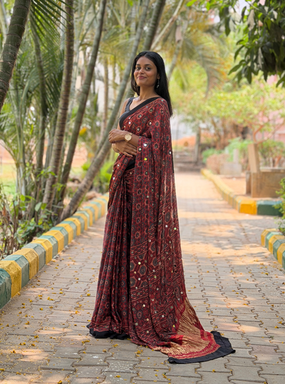 Rust Red Modal Silk Saree with Mirror Work & Ajrakh-Inspired Prints