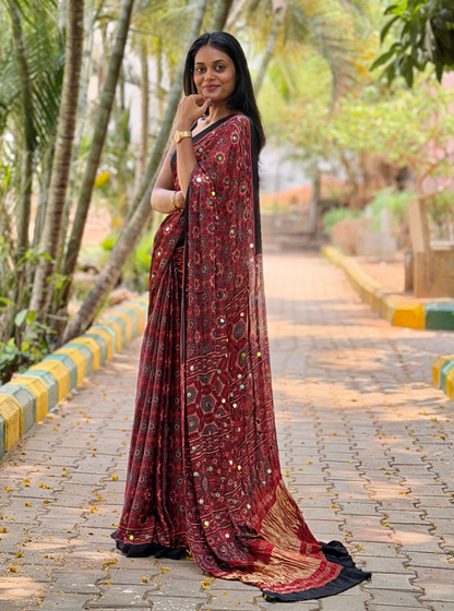 Rust Red Modal Silk Saree with Mirror Work & Ajrakh-Inspired Prints