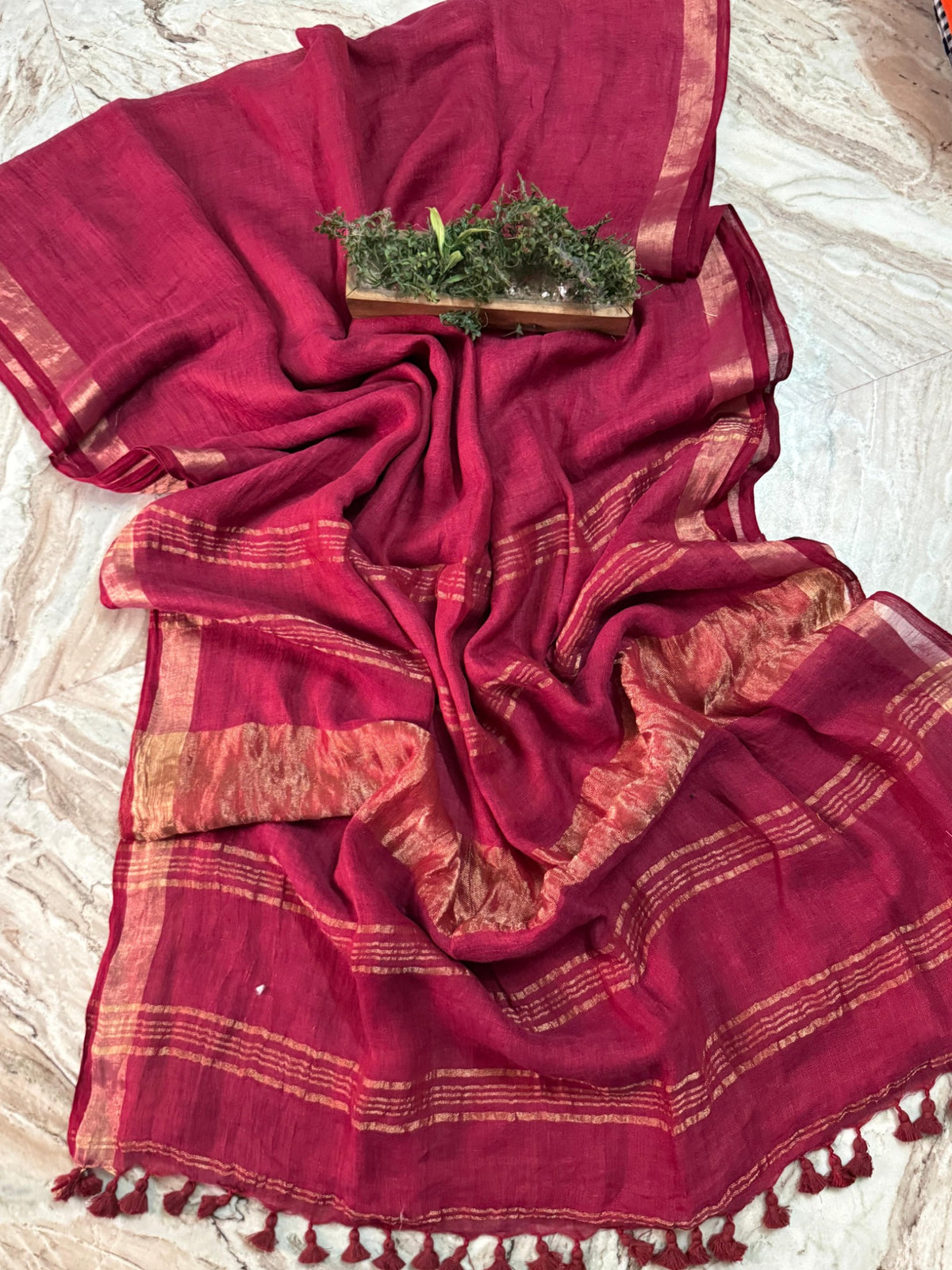 Berry maroon linen cotton handloom saree with copper-gold border, striped pallu and tassels