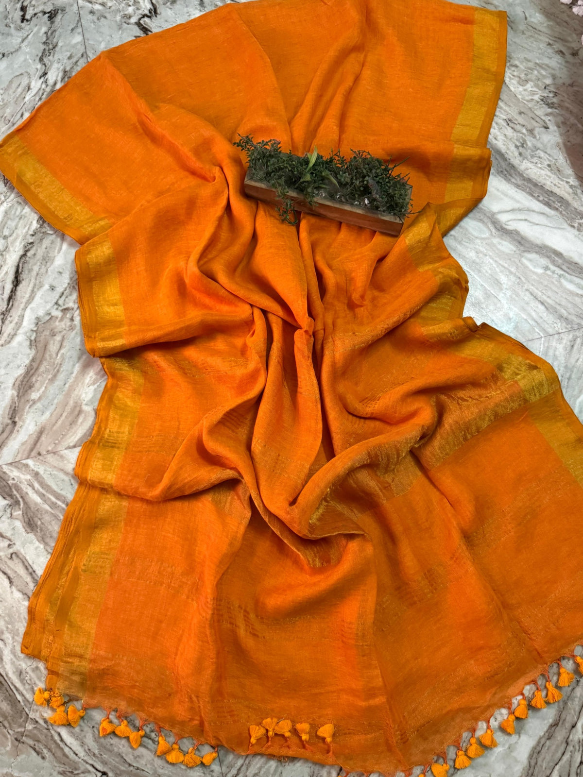 Bright orange linen cotton handloom saree with golden border and orange tassels