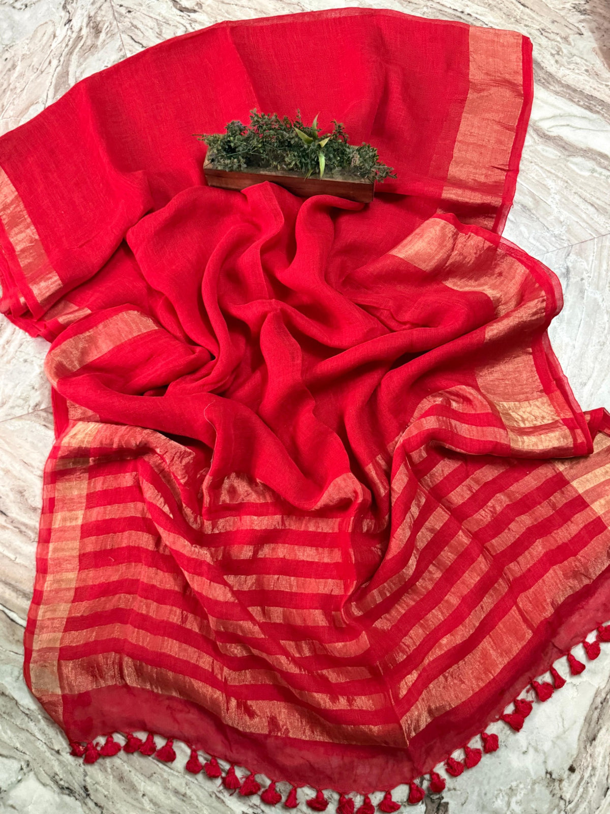 Bright red linen cotton handloom saree with copper-gold striped pallu, border and red tassels