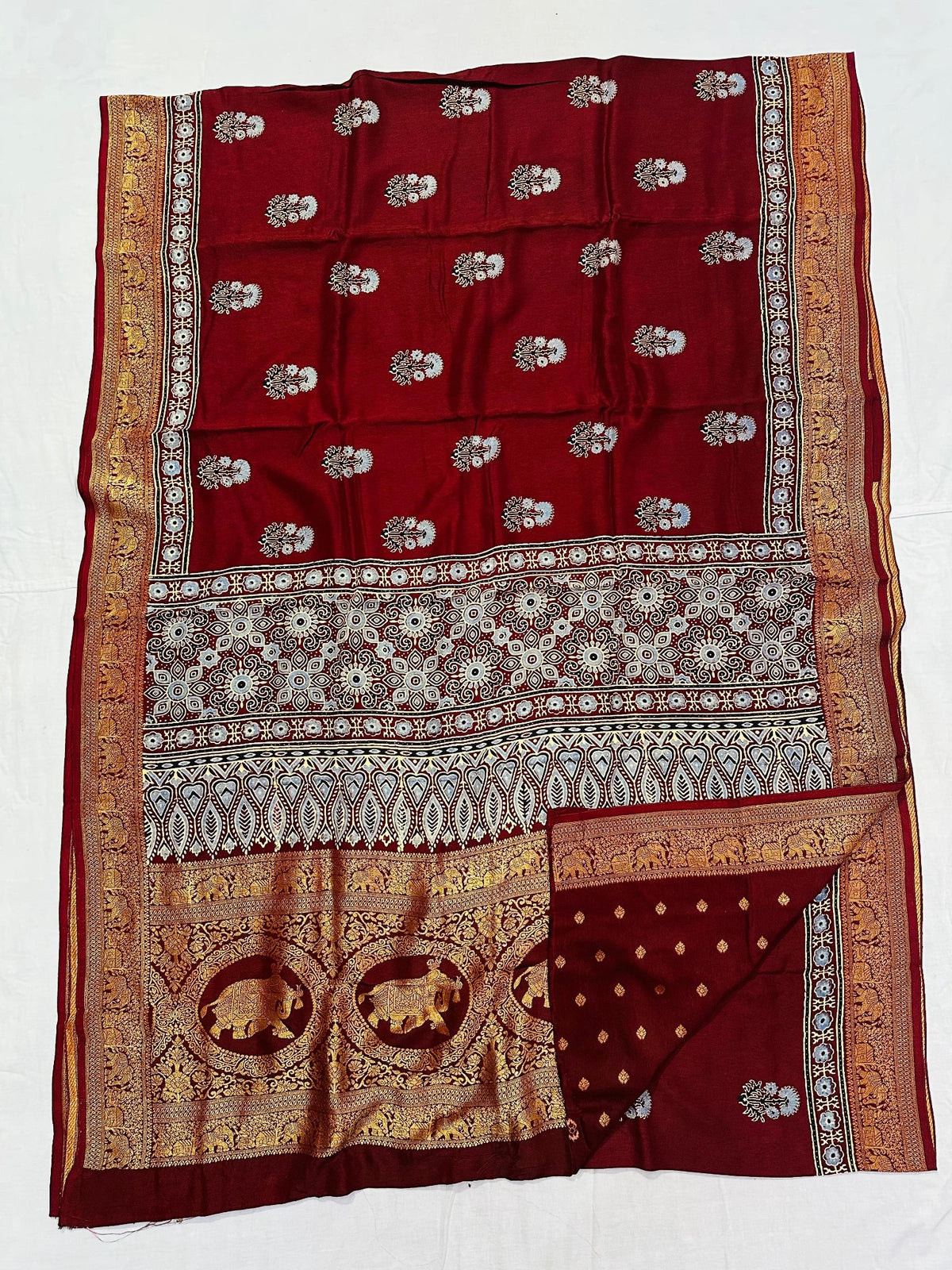 Deep maroon Dola silk Ajrakh handblocked saree with paisley motifs and antique gold elephant border