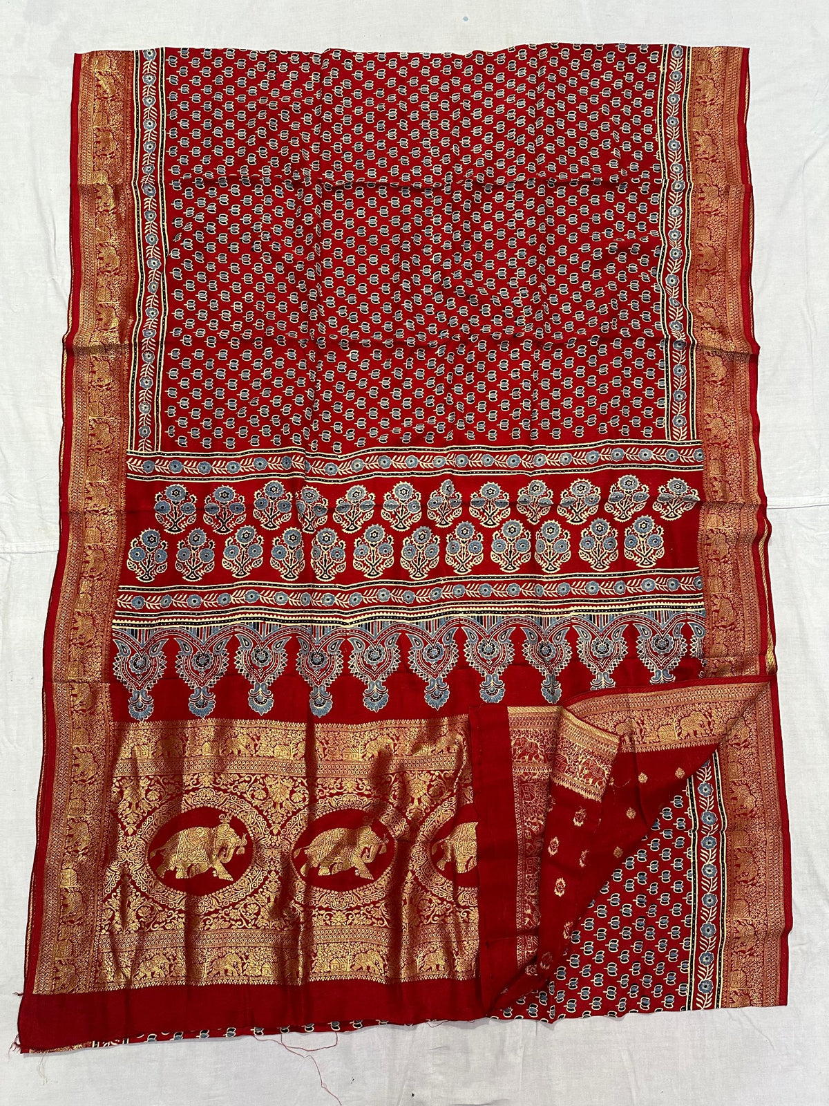 Red Dola silk Ajrakh handblocked saree with floral motifs, paisley borders and ornate gold elephant pallu