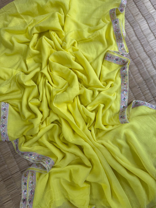 Lemon yellow mul cotton saree with pastel floral embroidered lace border