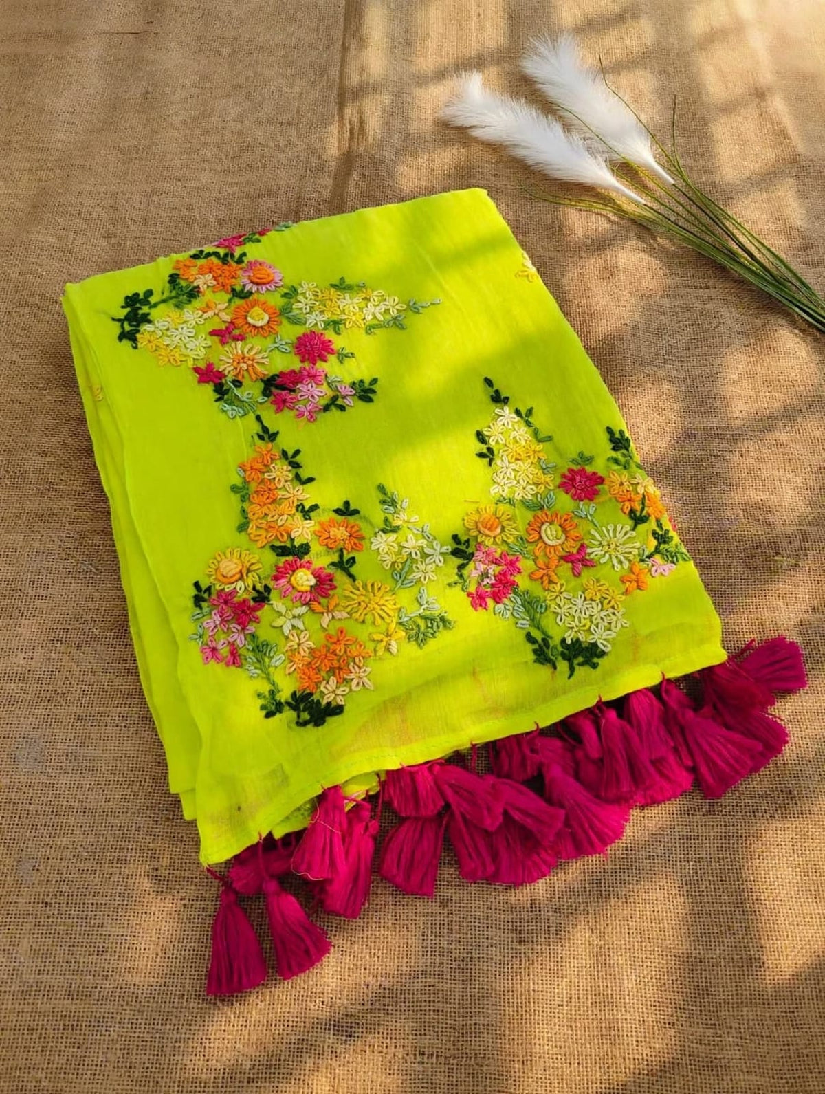 Lime yellow mul cotton saree with multicolour floral embroidery and fuchsia tassels