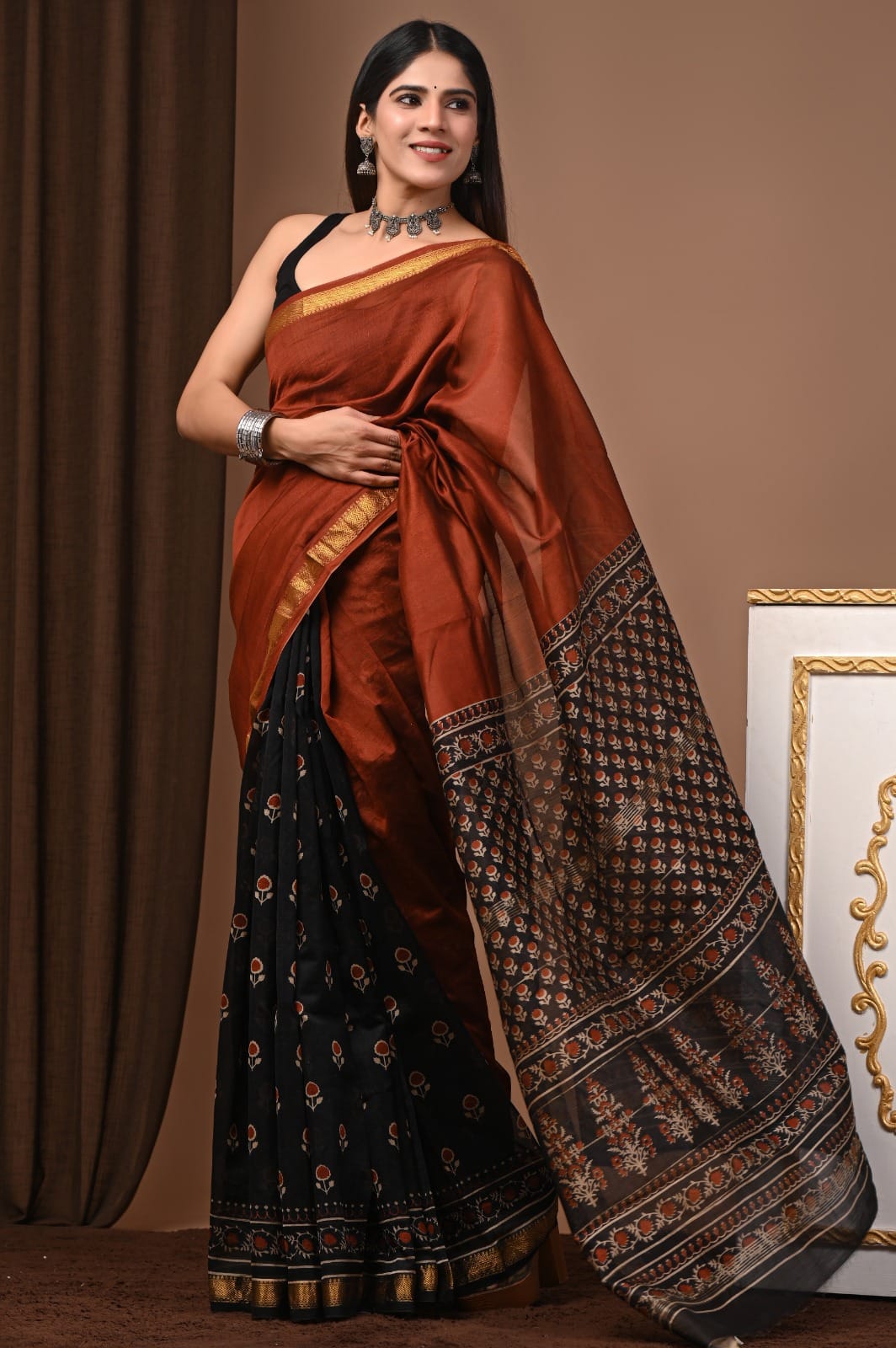 Rust & Black Maheshwari Silk Ajrakh Saree with Gold Zari Border, Floral-Printed Black Pallu and Traditional Ajrakh Motifs