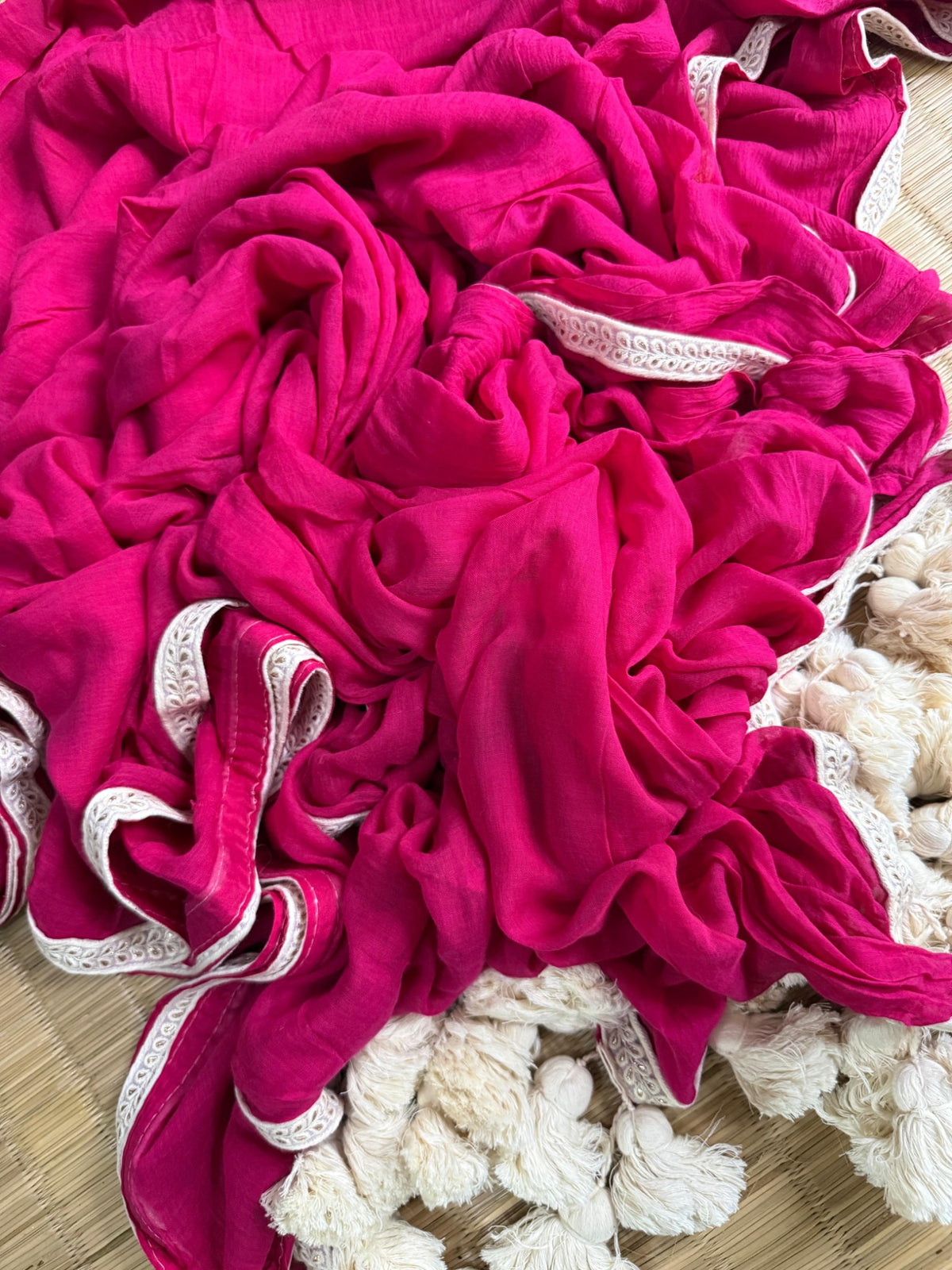 Magenta pink mul cotton saree with ivory embroidered lace border and ivory tassels
