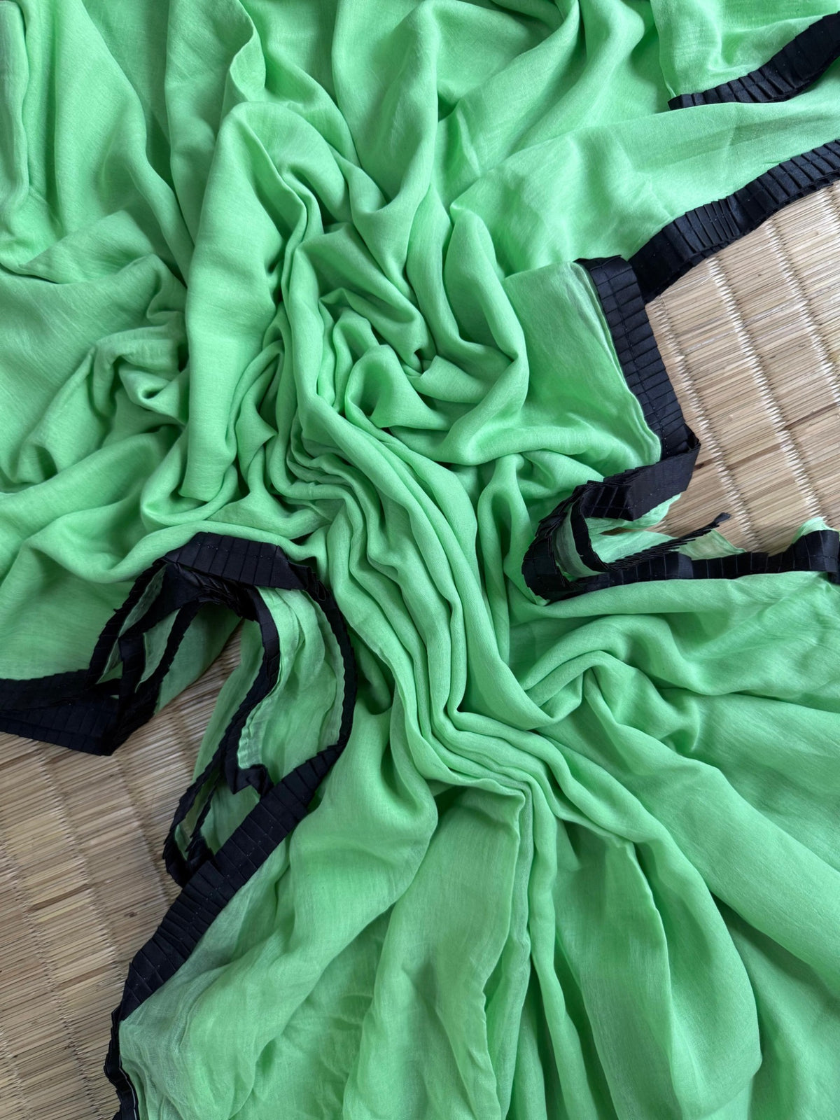 Mint green mul cotton saree with black pleated lace border