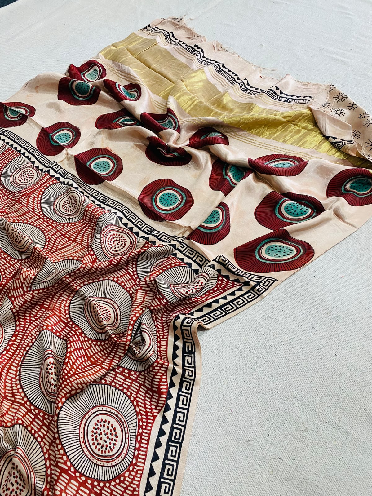 Ivory Modal Gajji silk saree with maroon and teal circular motifs, rust-red printed pallu, black geometric border and mustard-gold section