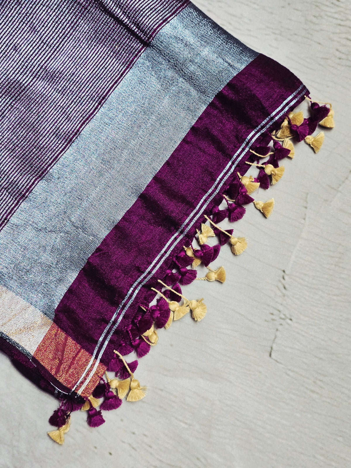 Deep wine plum Mul Cotton saree close-up with silver zari and tassels