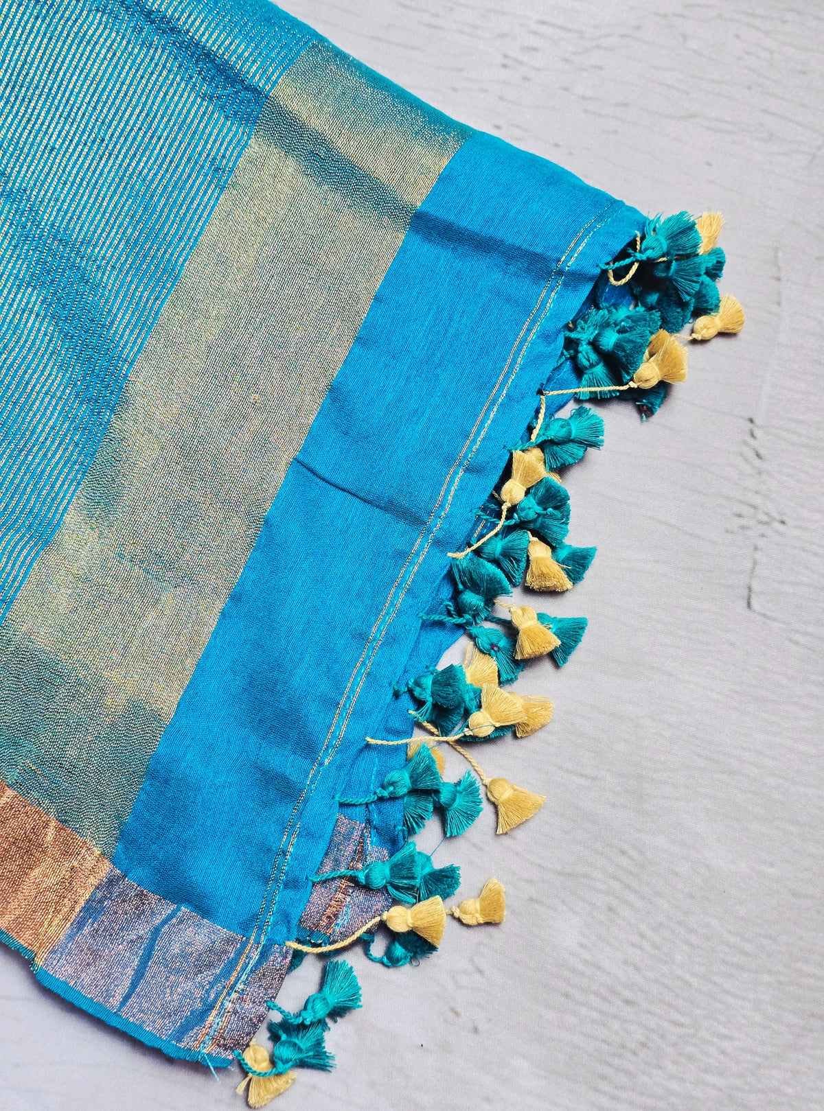 Bright turquoise blue Mul Cotton saree close-up with zari and tassels