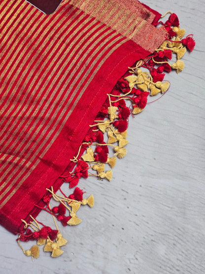Vibrant red Mul Cotton saree close-up with zari stripes and tassels