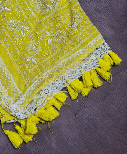 Sunshine yellow Mul Cotton saree close-up with ivory floral embroidery and tassels