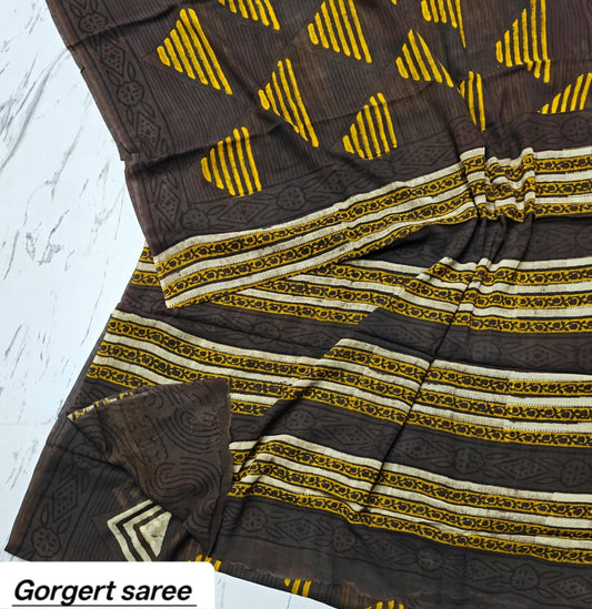Dark brown georgette saree with mustard yellow motifs and striped border