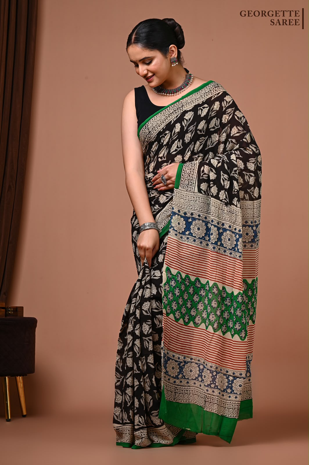 Black Georgette Ajrakh saree with ivory motifs and green accents