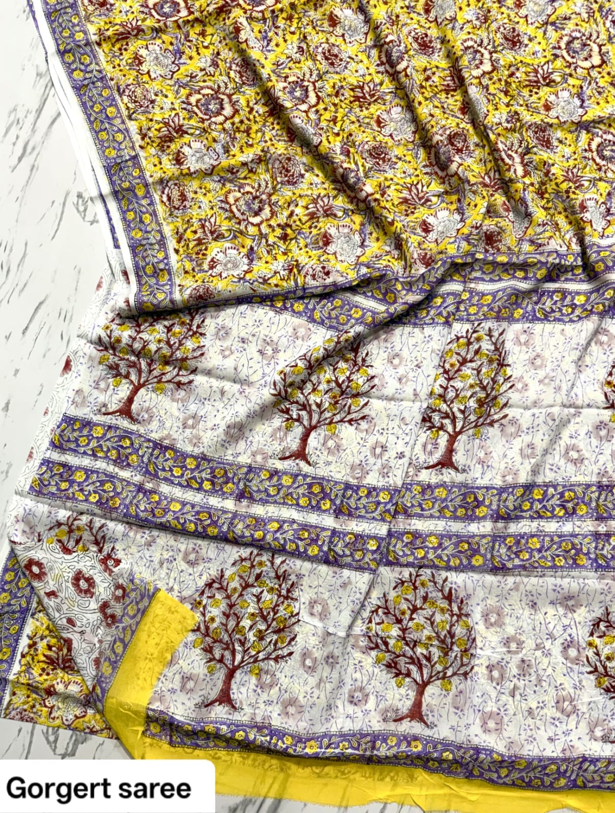 Mustard yellow and ivory georgette saree with tree motifs and purple border