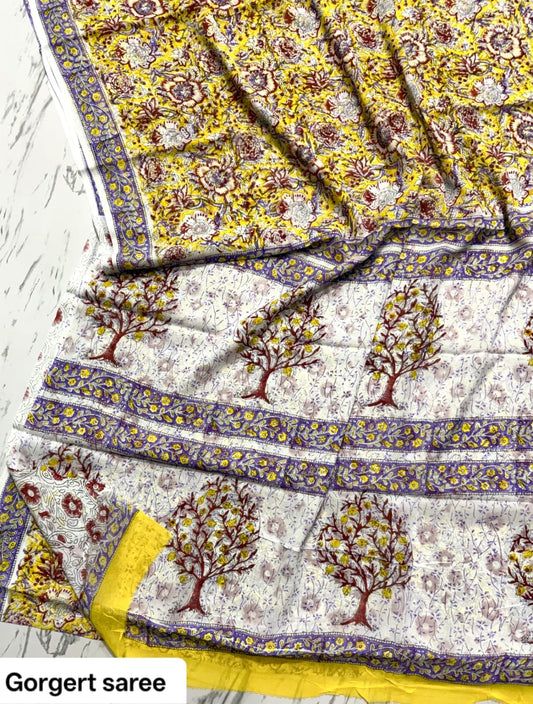 Mustard yellow and ivory georgette saree with tree motifs and purple border