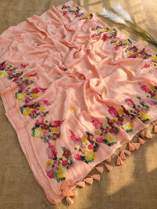 Peach mul cotton saree with multicolour floral embroidery and peach tassels