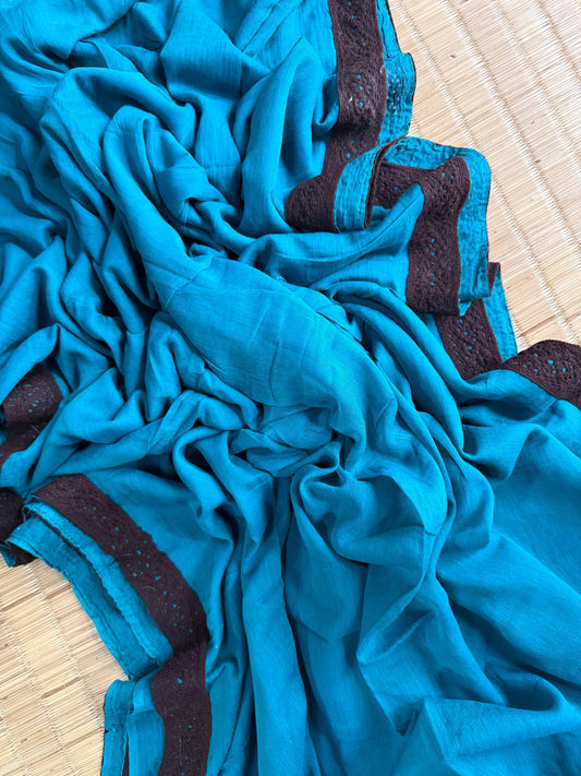 Turquoise blue mul cotton saree with dark brown lace border and subtle blue detailing